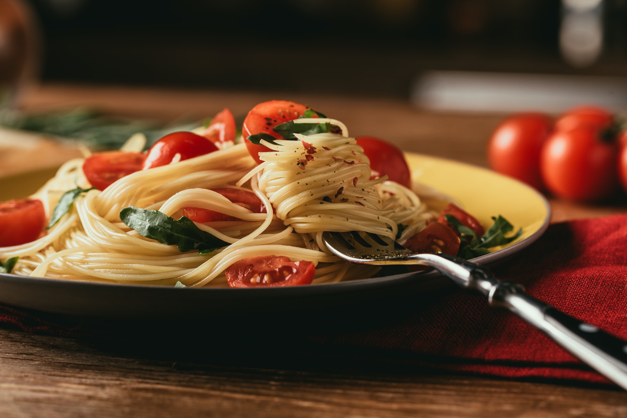 traditional italian pasta with tomatoes and arugula in plate